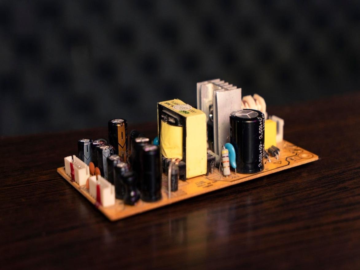 Clean switching power supply PCB with transformer, heat sink, capacitors, and connectors