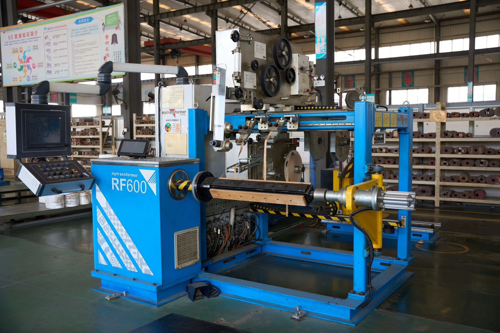 Automatic transformer winding machine on a factory floor